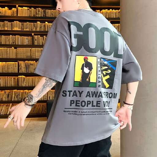 a man in a grey shirt is pointing at something.