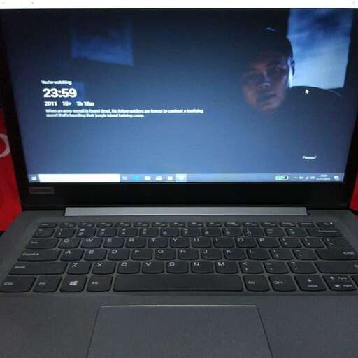 a laptop computer with a picture of a man on the screen.