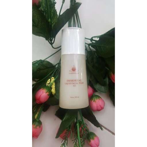 a bottle of lotion with a flower in it.