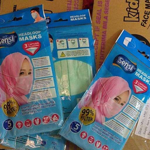 a package of a person with a pink head scarf on it.