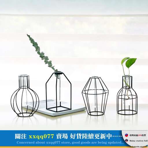 a set of three bird cages with a plant in it.