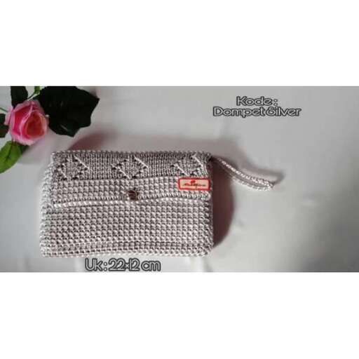 a bag made of crochet and a flower
