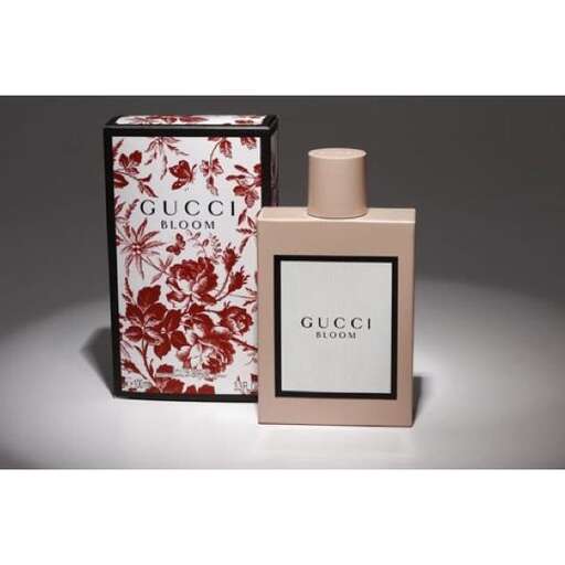 a beautiful perfume bottle with a red flower pattern.