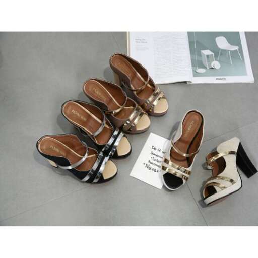 a pair of sandals with a black strap.