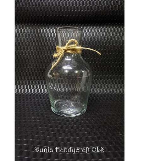 a small glass bottle with a string tied around it.