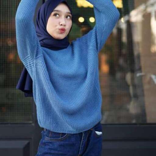 a girl in a blue sweater