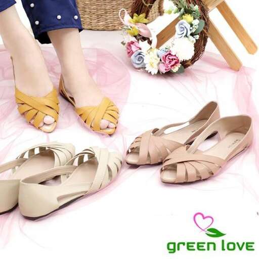 a pair of tan shoes with a pink heart on the front.