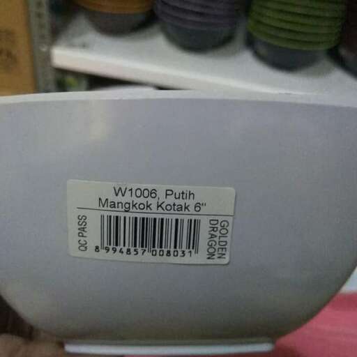 a person holding a bowl with a label on it.