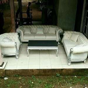 a white couch sitting in front of a black table.
