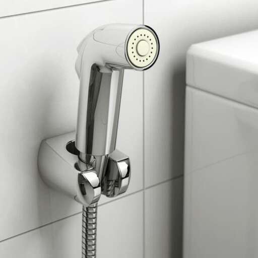 a faucet in a bathroom with a clock on the wall.