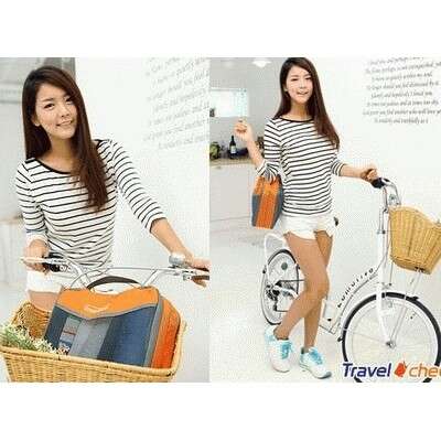 a woman in a striped shirt is holding a bike.