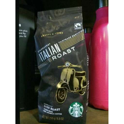 a black bag of coffee sitting on a table.