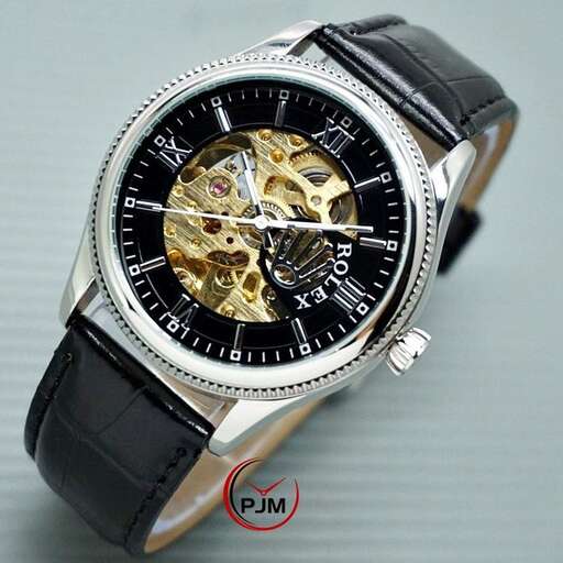 a watch with a black face and gold dial.