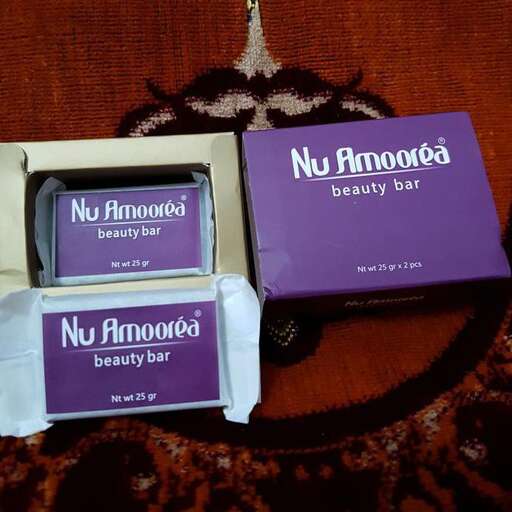 two boxes of beauty products sitting on a couch.