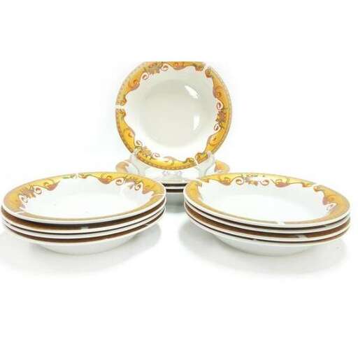 a set of plates, including a round plate, with a round white oval plate.