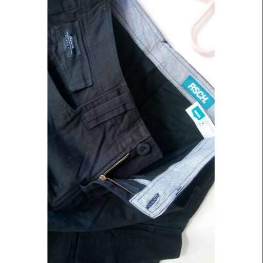 a pair of jeans with a tag on the front.