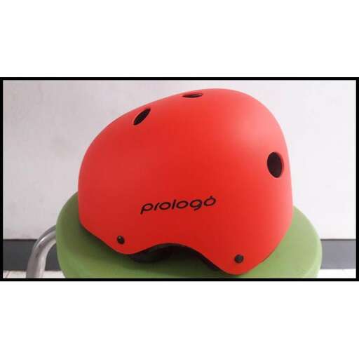 a red helmet with a black dot on it.