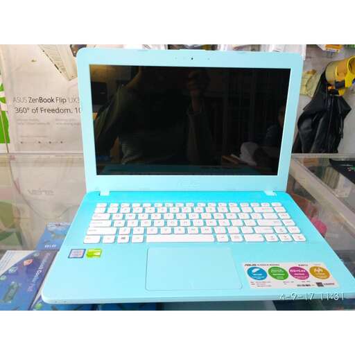 a laptop computer sitting on a table in a store.