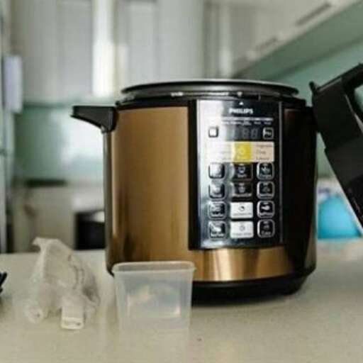 a coffee maker sitting on a counter next to a plastic cup.