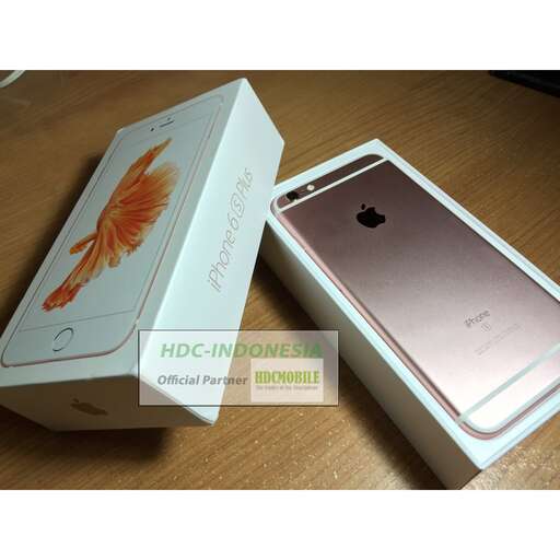 a box with a gold leaf on it and a white phone in it.