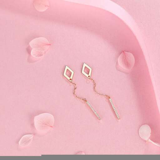 a pair of gold earrings with pink flowers