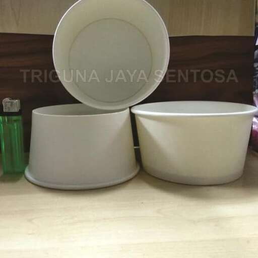 a white bowl and a bowl on a table.
