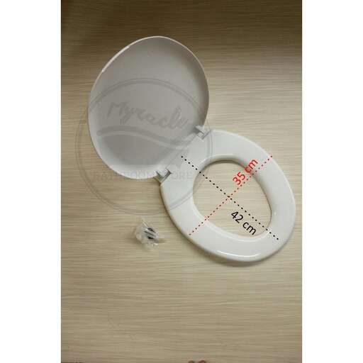 a small white plate with a small hole in the middle.