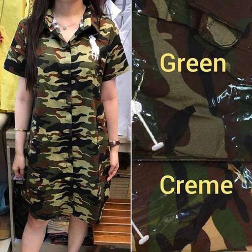 a woman in a military uniform standing next to a green cone.
