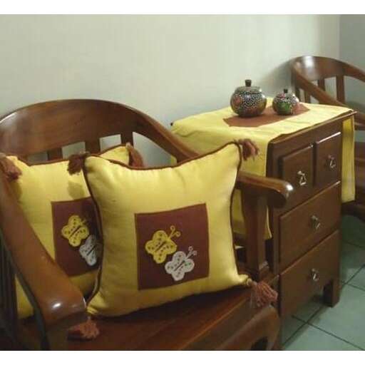a set of furniture with pillows and a teapot on top.
