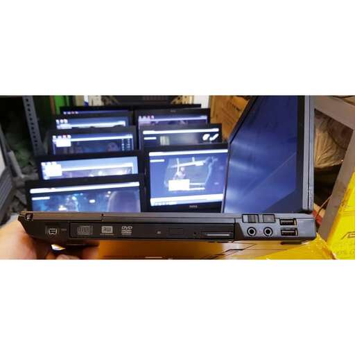 a person holding a laptop in their hand.