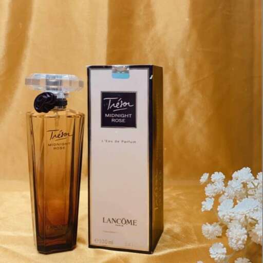 a bottle of perfume sitting on a table.