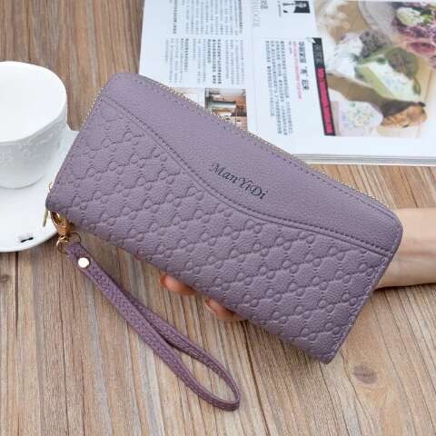 a purse with a handle sitting on a table.