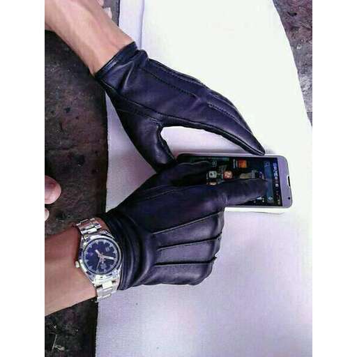 a person wearing a glove and a watch on their wrist.