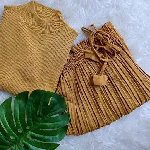 a yellow blouse with a brown bow on the front and a green leaf in the front.