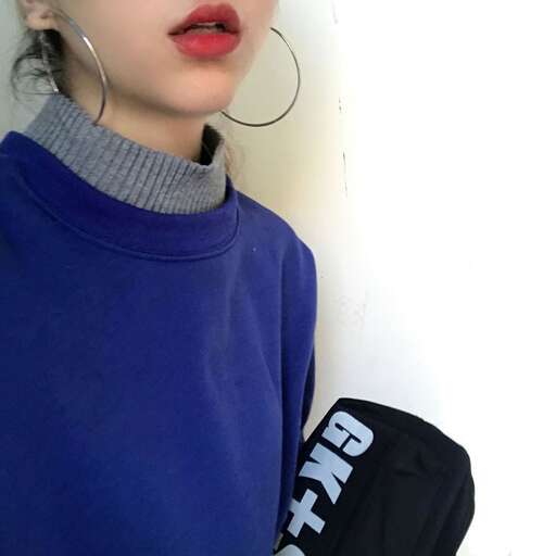 a long sleeved sweater with a hoodie and a pair of hoop earrings