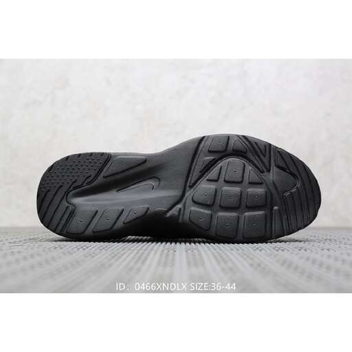 a black shoe that is on a white surface.