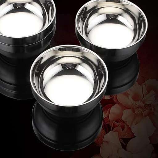 a pair of black and white glass bowls with a white background.