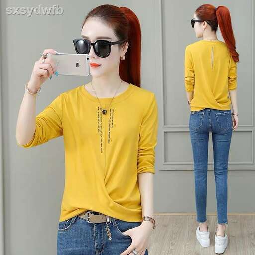 a girl in a yellow shirt and jeans