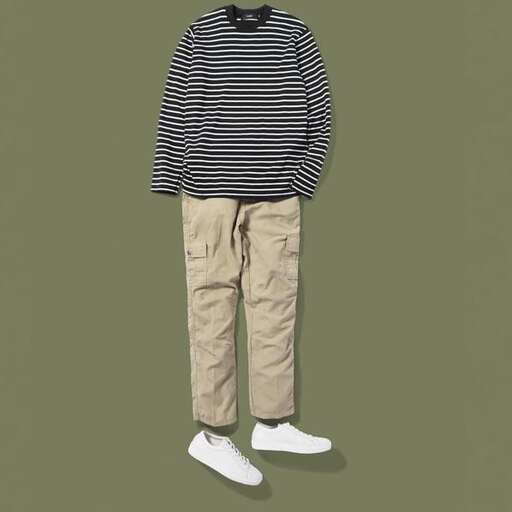 a boy with a striped sweater and white shoes.