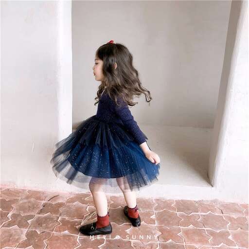 a little girl in a blue dress