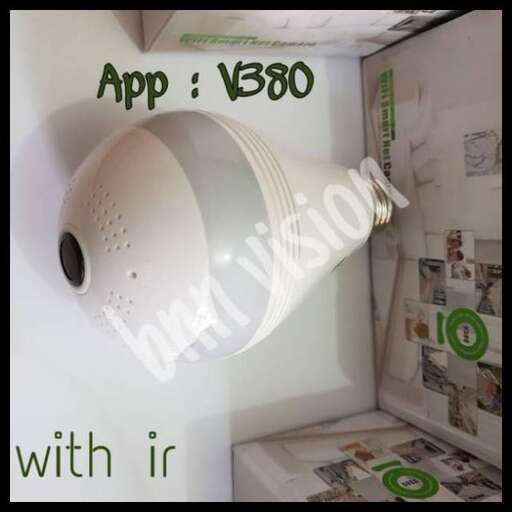 a white lamp hanging from the ceiling of a room.
