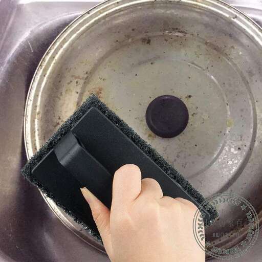 a hand holding a wallet in a sink.