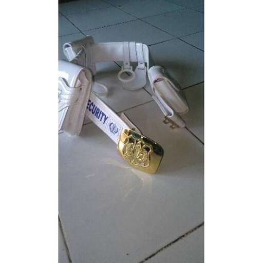 a metal ring laying on the floor with a strap.
