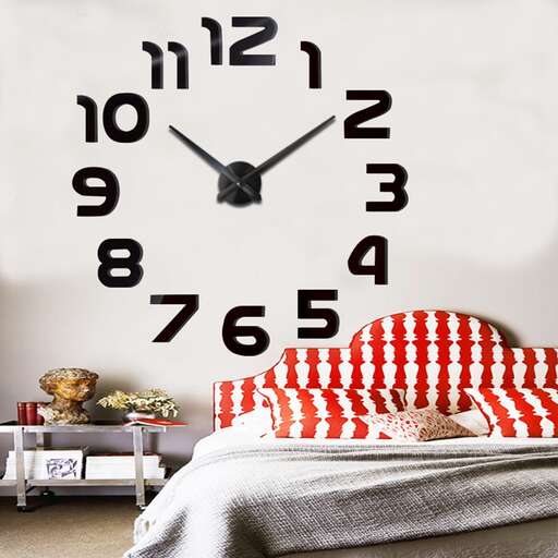 a clock on a wall above a bed.