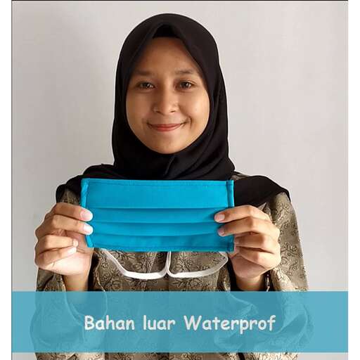 a girl in a black hijab holding a blue card