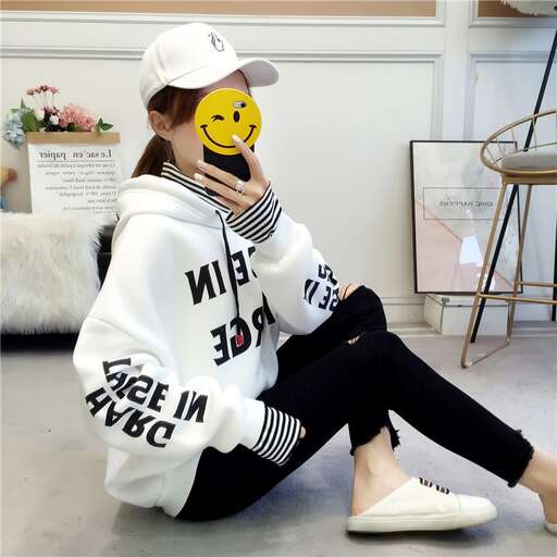 person in a white hoodie and black leggings