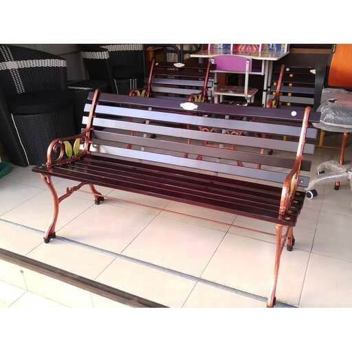 a bench with a metal frame and a white floor.