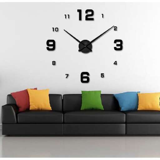 a black couch with a clock on the wall and a couch