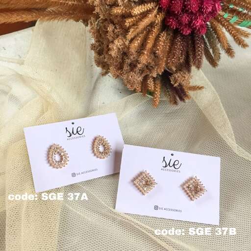 a pair of earrings with a flower.