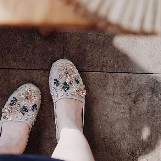 a woman's feet with floral pattern on them.